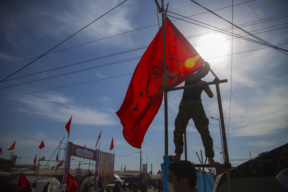 man holding red flag