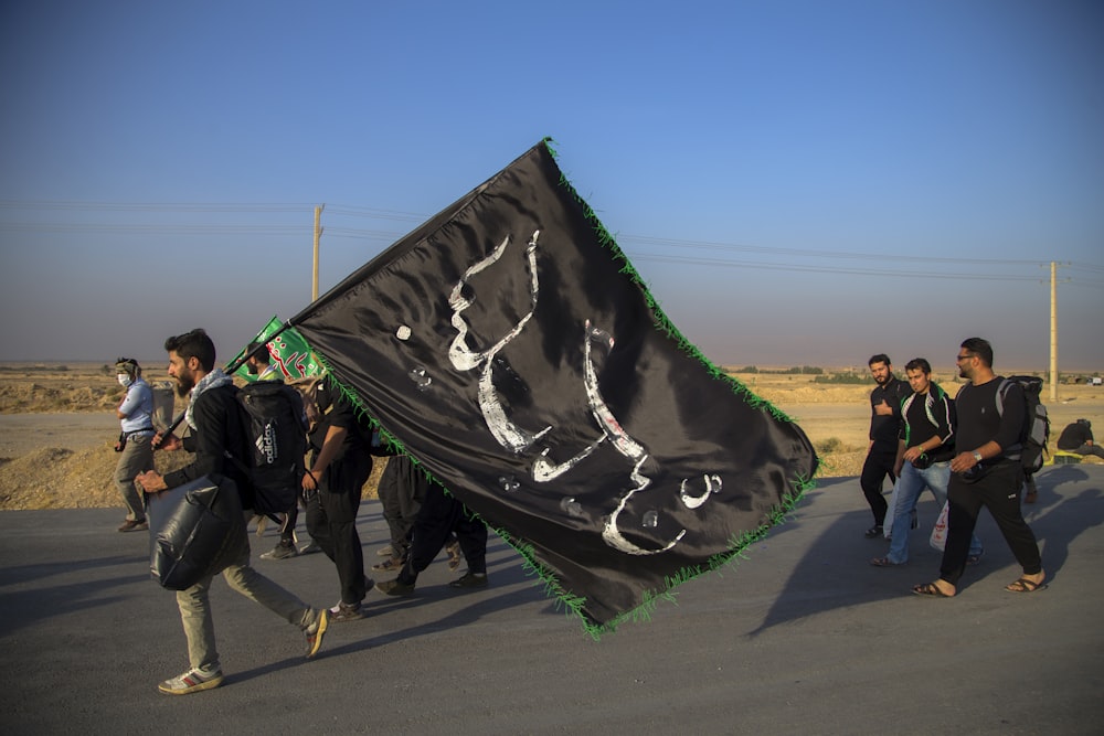 man holding flag while walking with other men