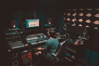 person sitting on chair in front turned-on monitor