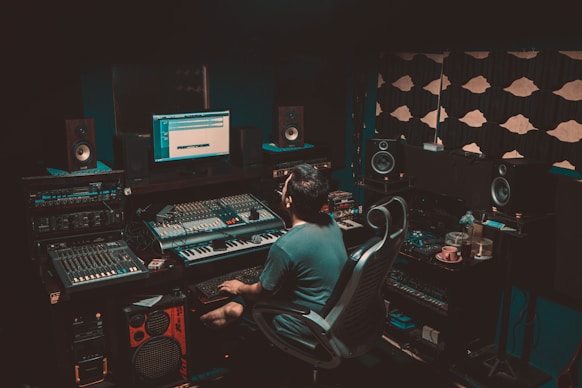 person sitting on chair in front turned-on monitor