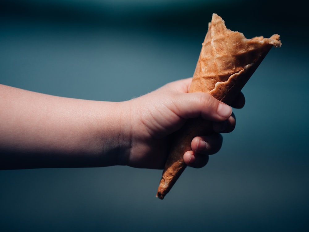 person holding brown cone