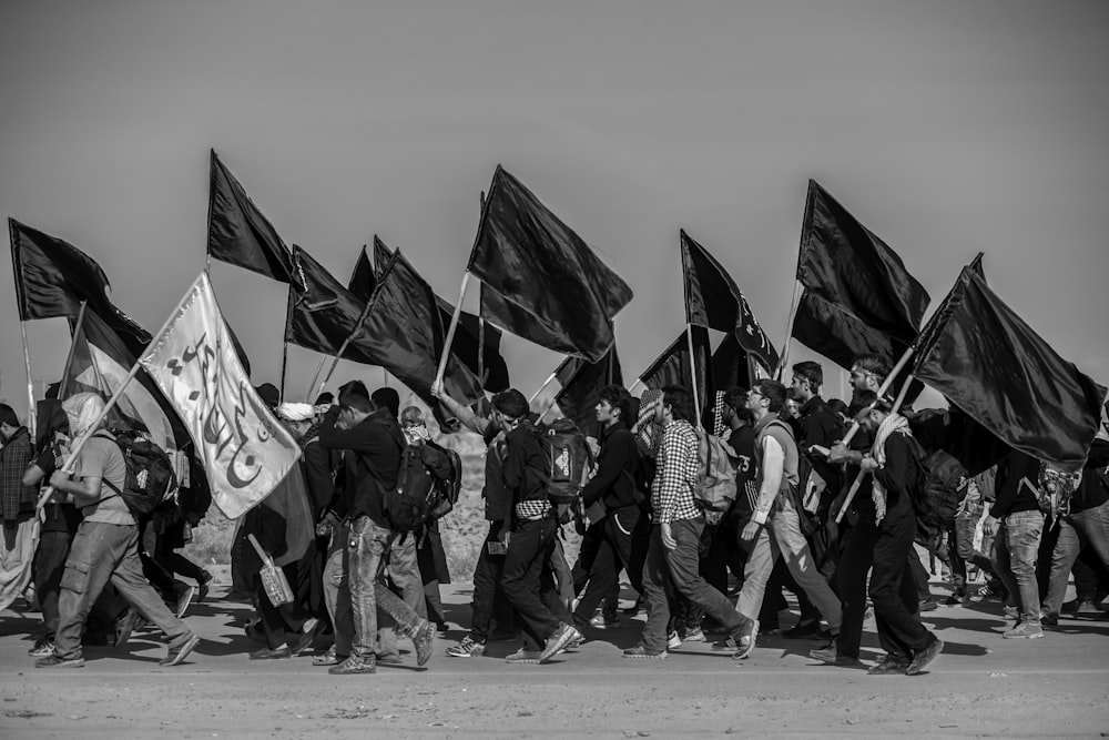 grayscale photography of group of person walking outdoors