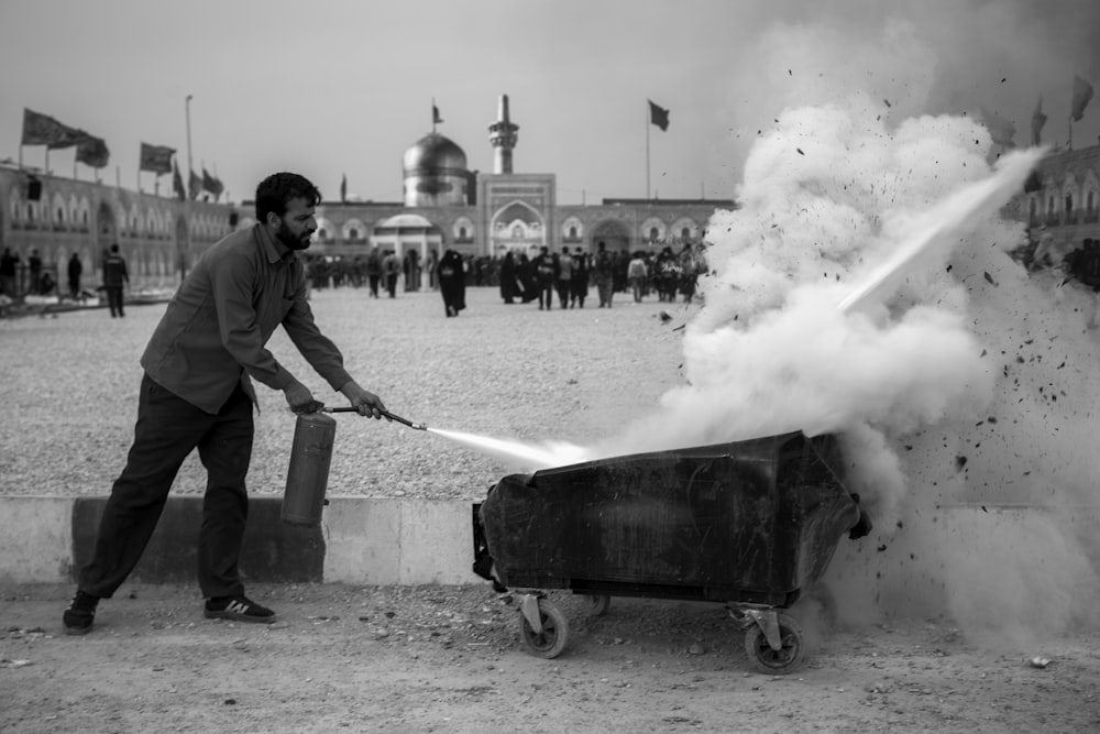 a man pulling a cart with a lot of smoke coming out of it