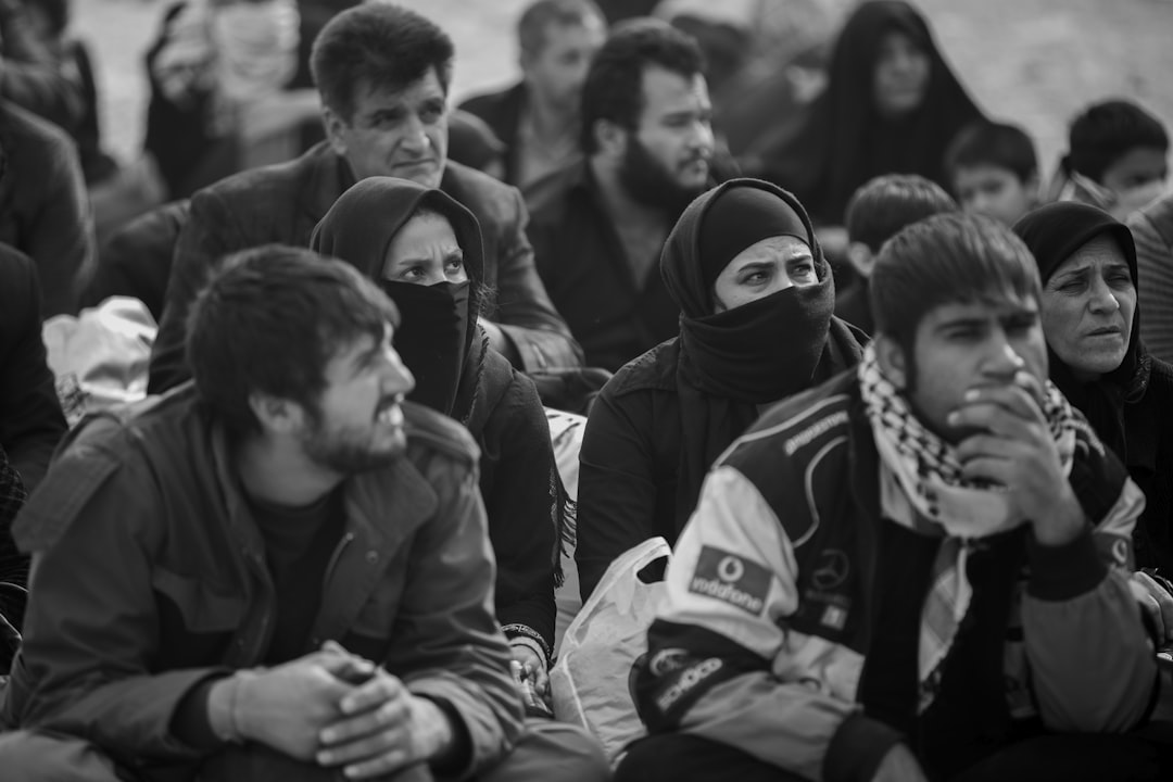 greyscale photo of people, Twelver or Imamiyyah is the largest branch of Shia Islam. The term Twelver refers to its adhe