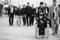 a group of men walking down a street
