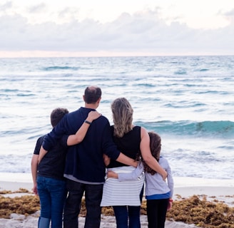 a family of four on a beach