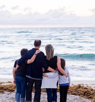 a family of four on a beach