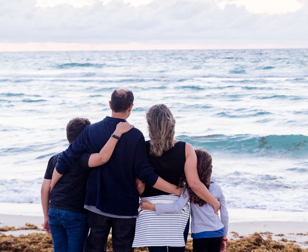 a family of four on a beach