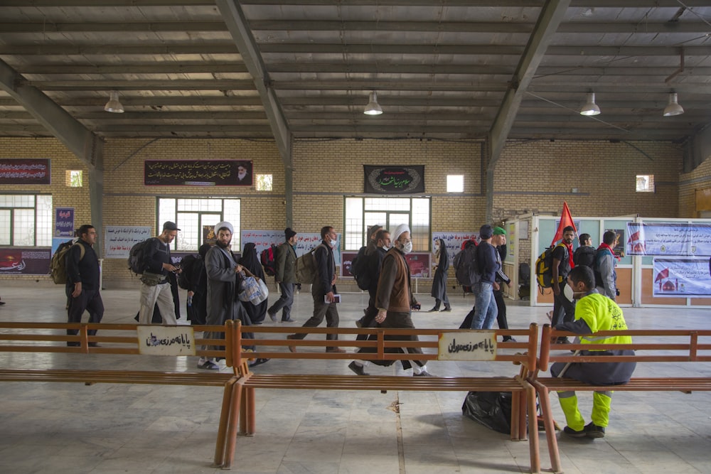 group of people walking inside structure