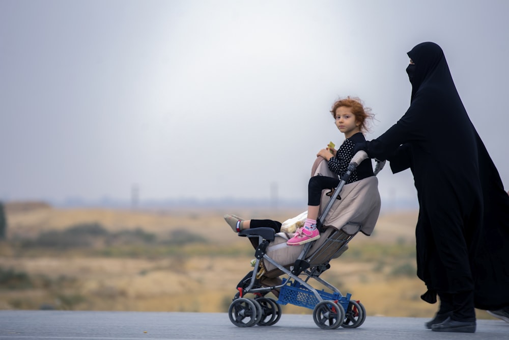 woman carrying stroller