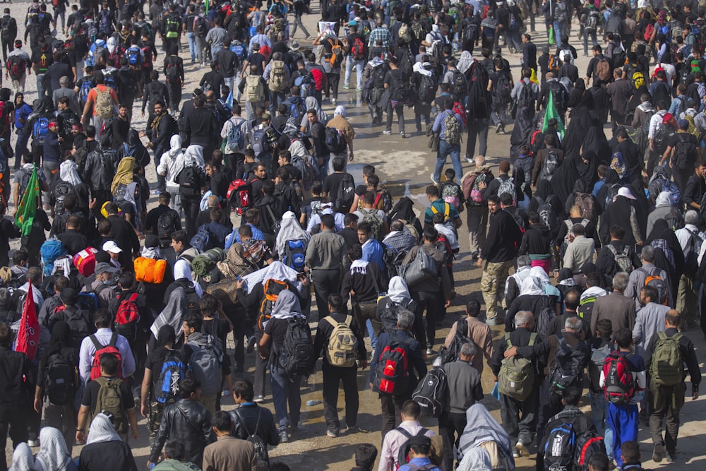 a large group of people walking down a street