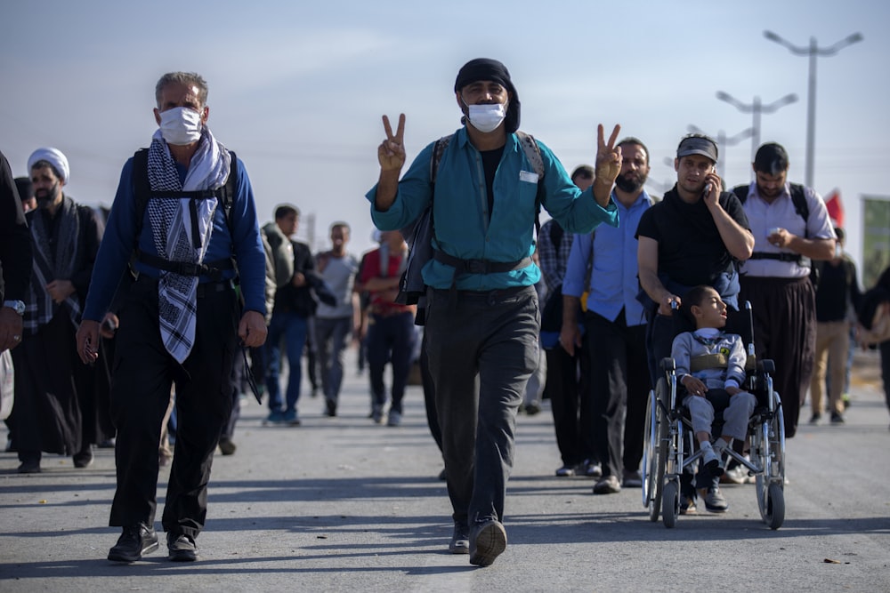 group of person walking on road