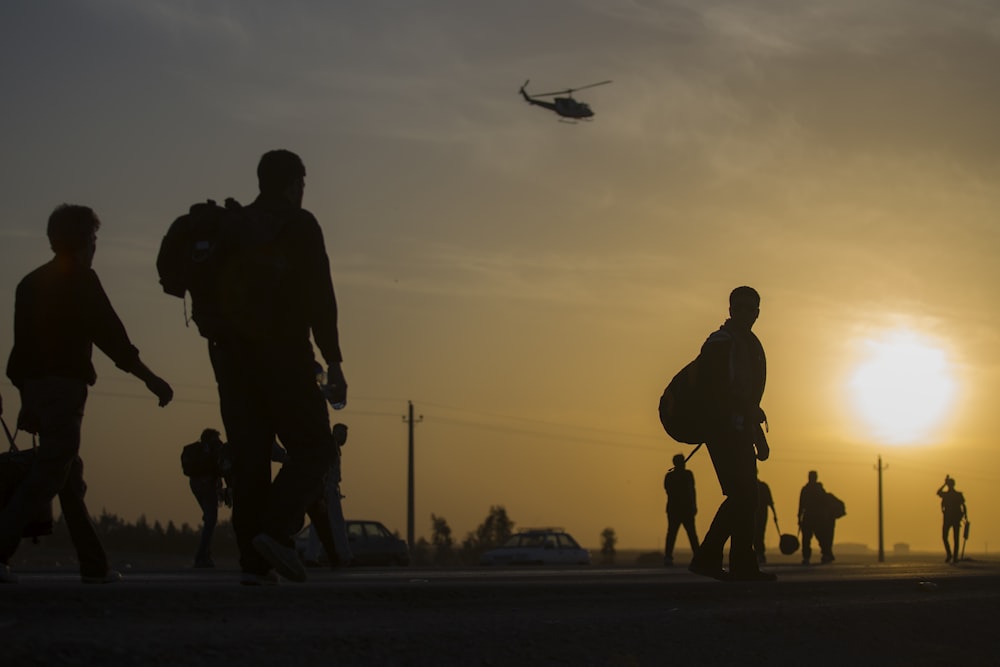 crowd walking at sunset