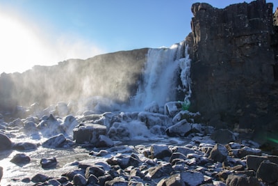 A majestic waterfall cascading down rocky cliffs in Iceland.
