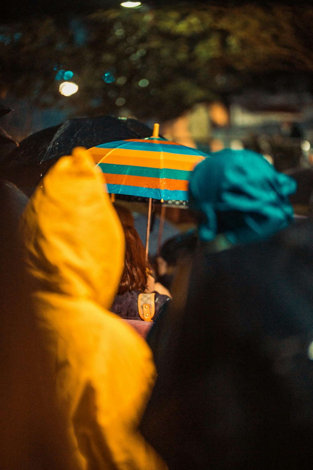 a group of people walking down a street holding umbrellas