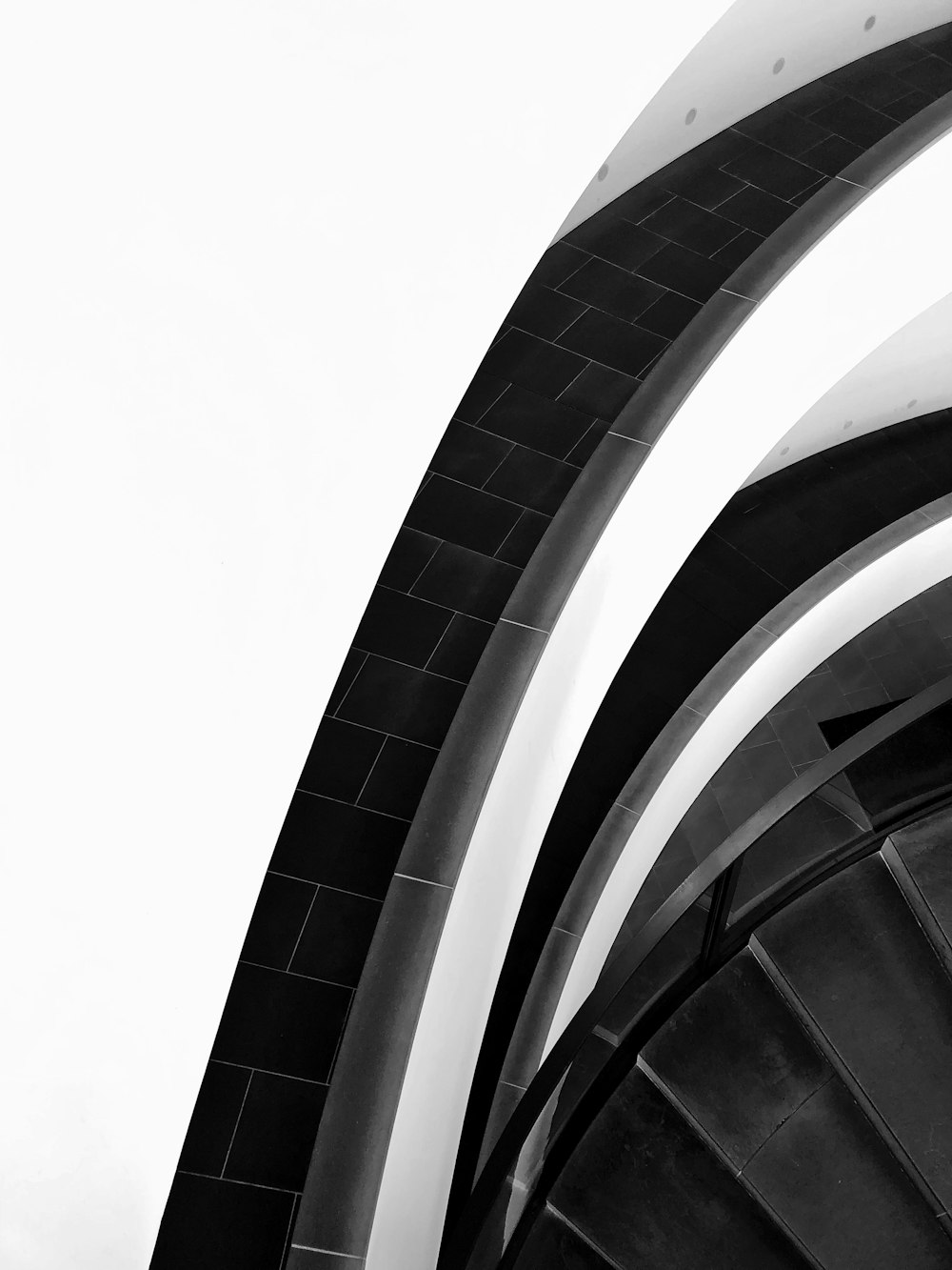 a black and white photo of a spiral staircase