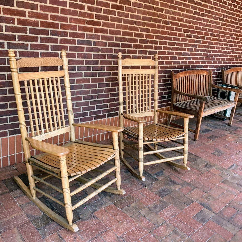 two brown wooden rocking armchairs