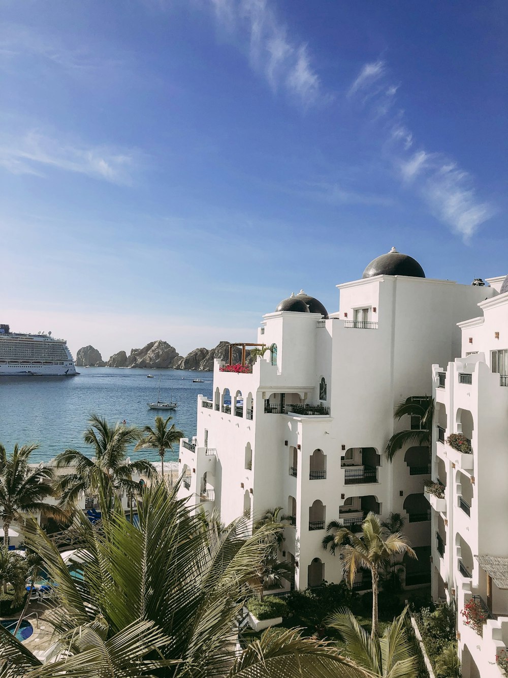 a cruise ship is in the background of a white building