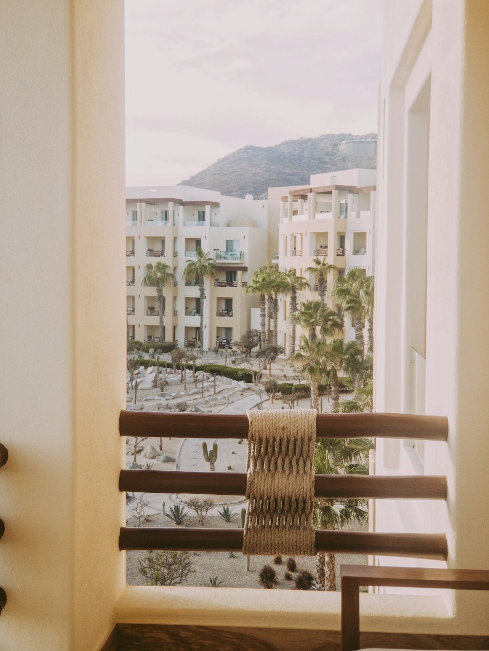 a balcony with a chair and a view of a city