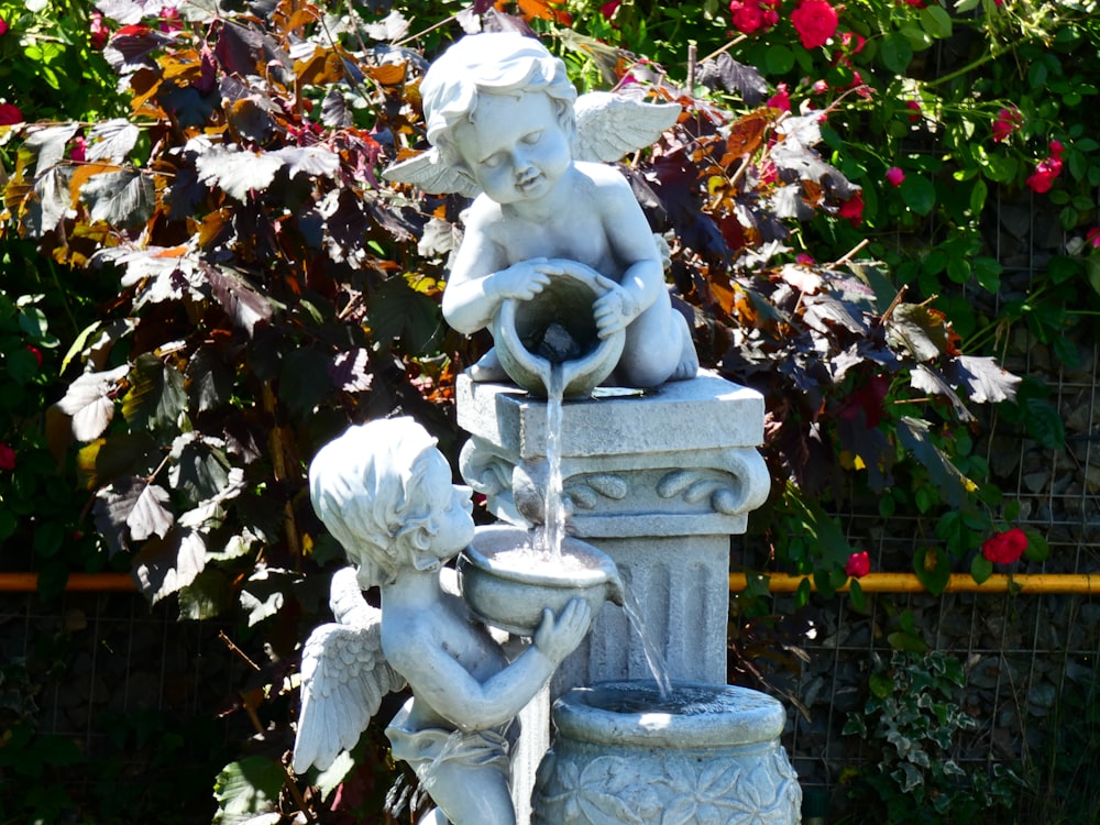 photography of two angels statue during daytime