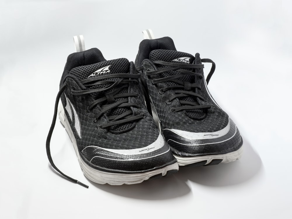 pair of black low-top running shoes