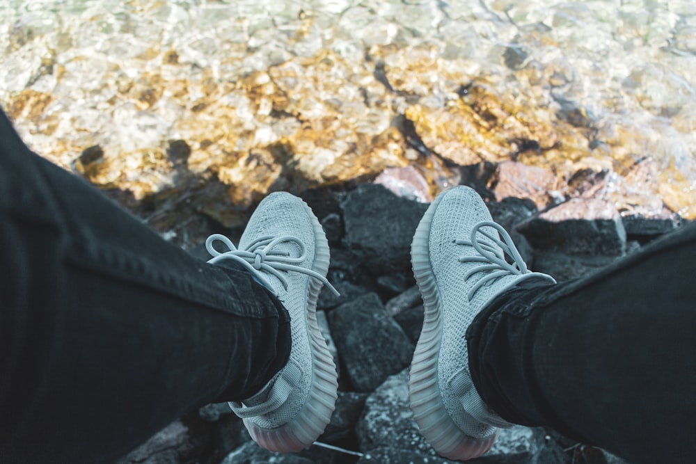 person wearing black denim jeans and adidas Yeezy Boost 350 V2 standing  photo – Free Fashion Image on Unsplash