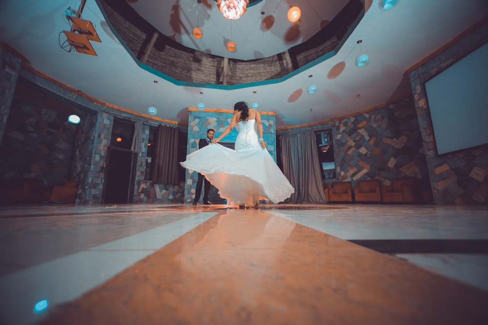 woman in white dancing in a ballroom