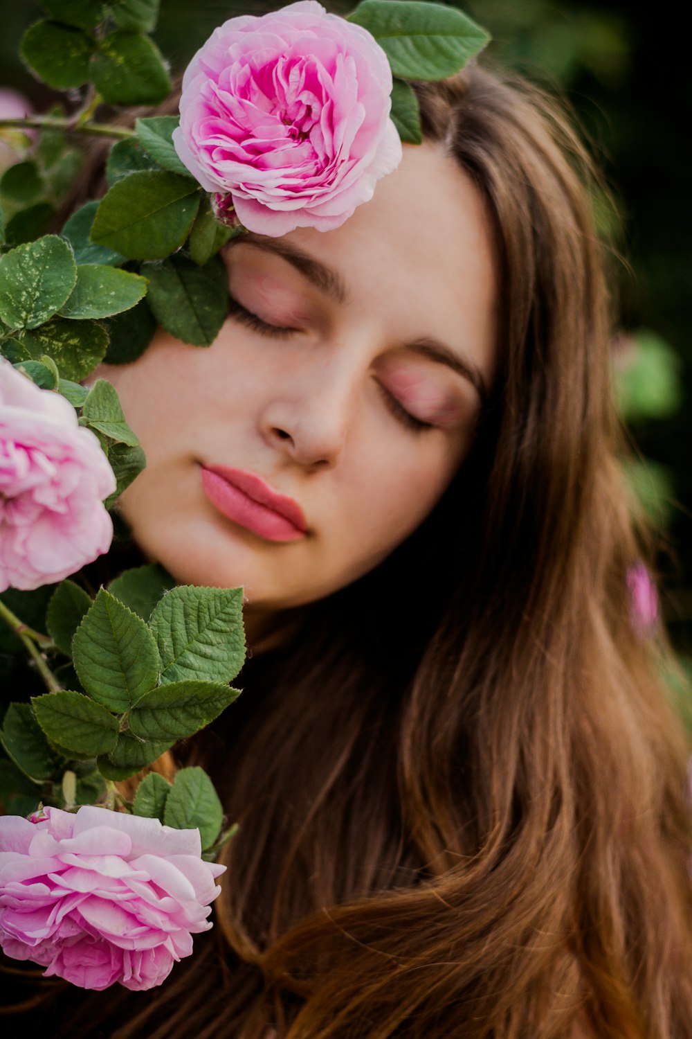 woman hiding pink fower