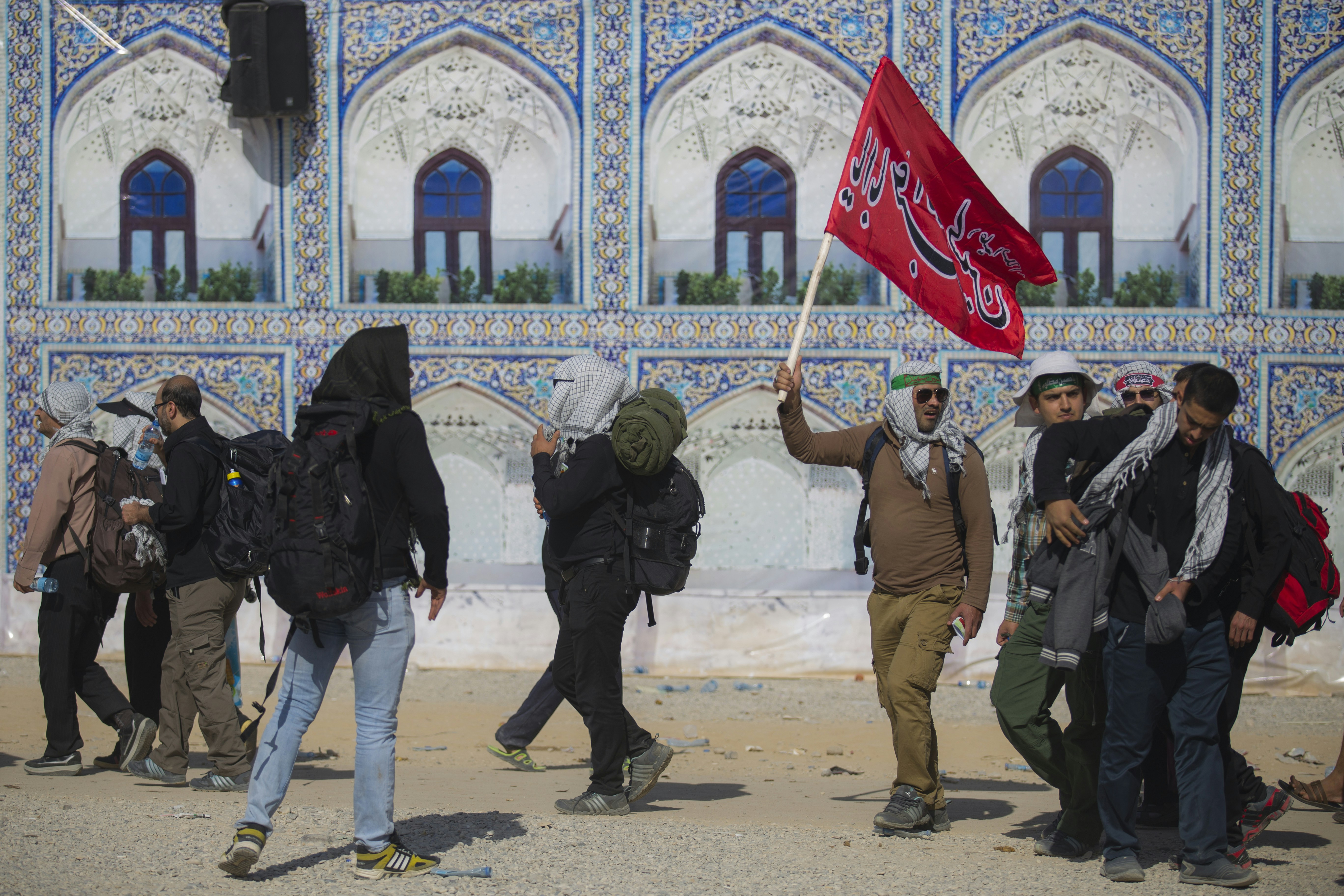 group of people standing outside building iranian teams background