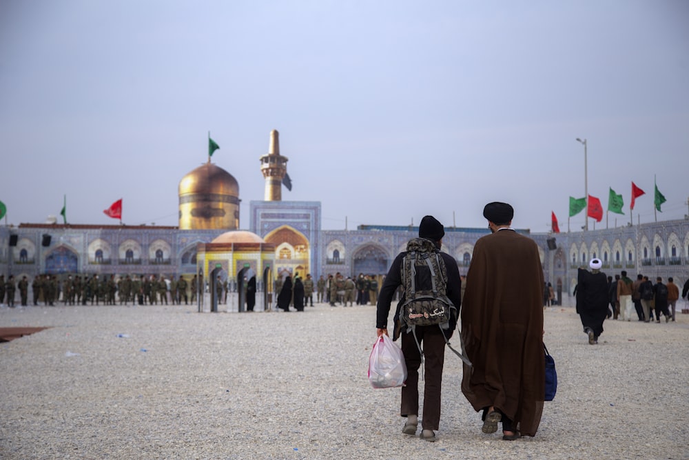 man and woman walking on soil