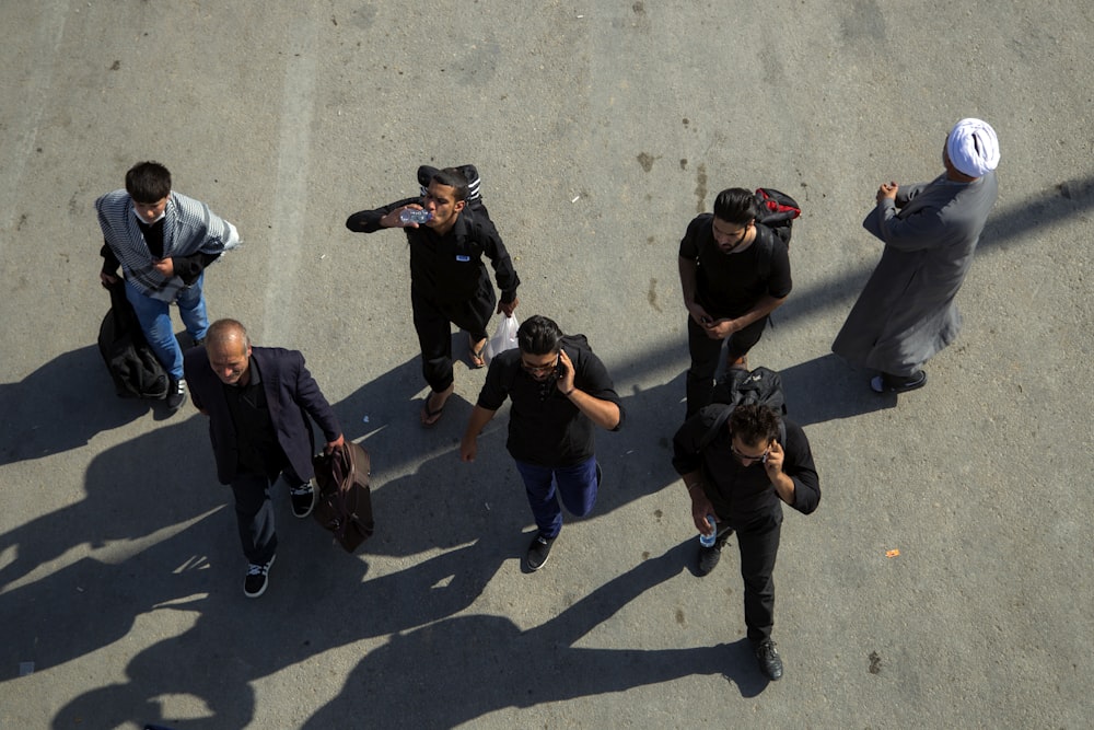 group of men walking on pavement