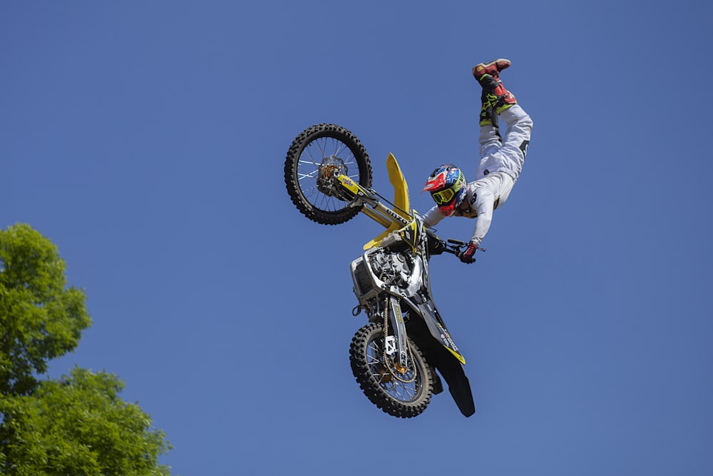 person doing motocross stunt on air during daytime