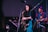 A professional saxophonist performing at a corporate event with guests enjoying.