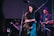 A professional saxophonist performing at a corporate event with guests enjoying.
