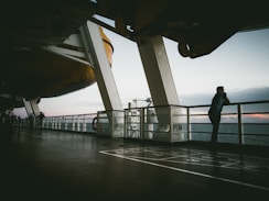 man standing near white balcony
