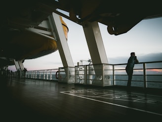 man standing near white balcony