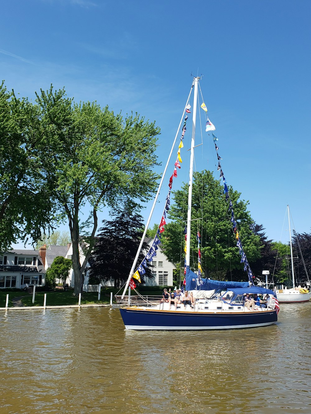 blue and white boat on body of water