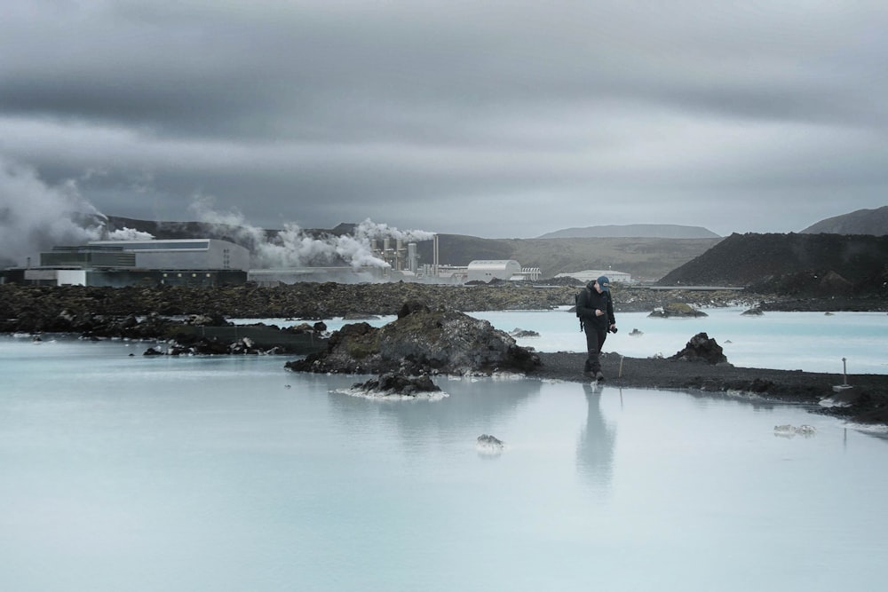 man standing between body of water