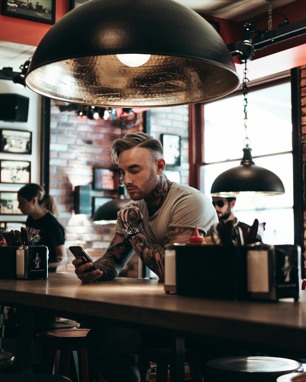 man sitting beside bar counter