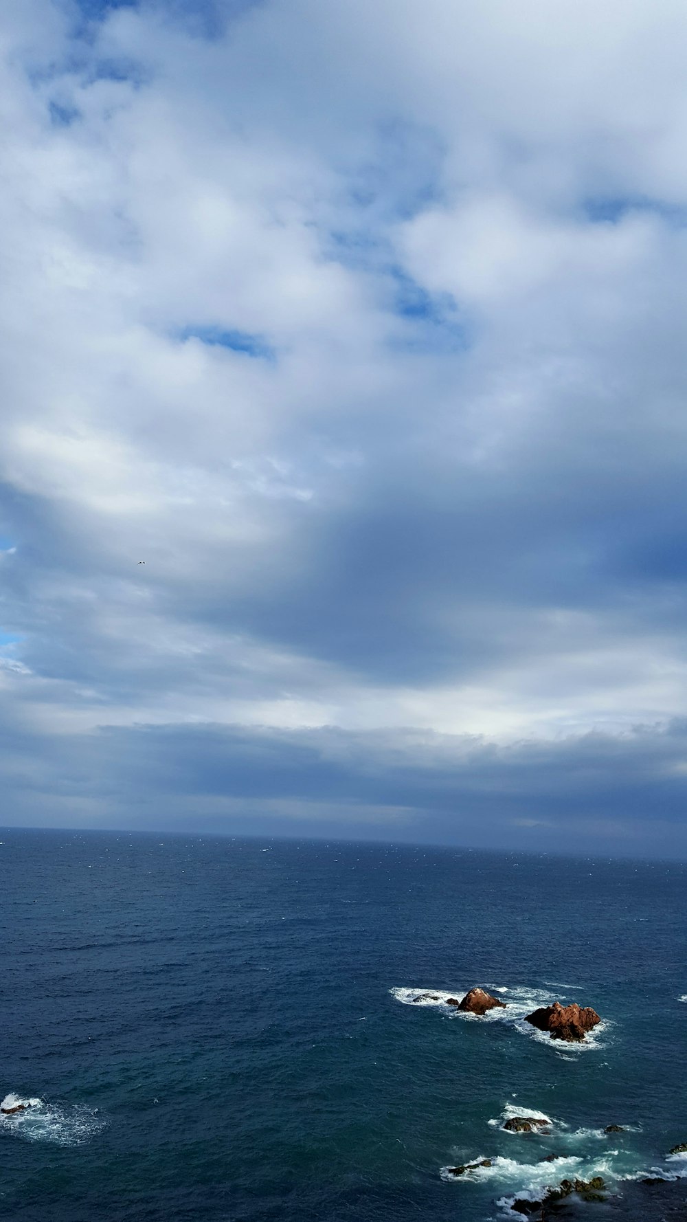 rocks on ocean during day