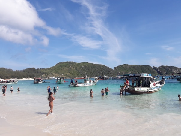 people on white sand beach during daytime