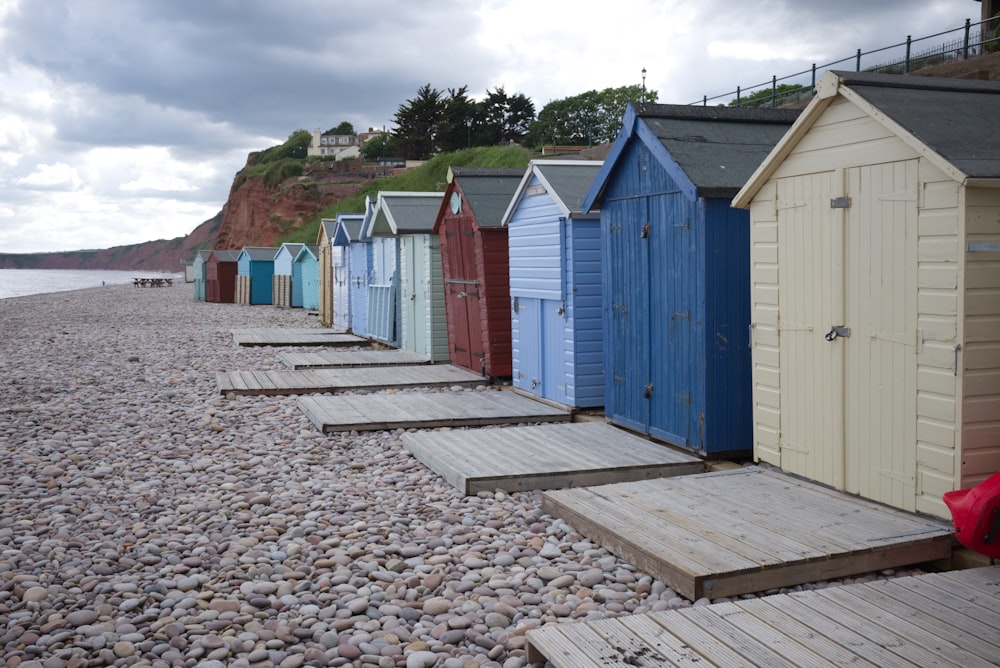 assorted-color sheds near shore during daytime