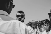 gray scale photo of man wearing sunglasses