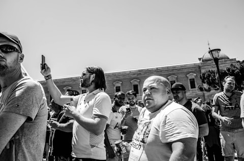 grayscale photography of group of person standing outdoors