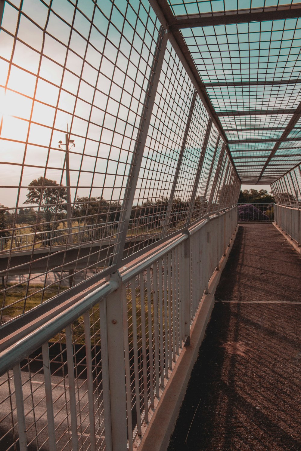 wire covered walk bridge over highway