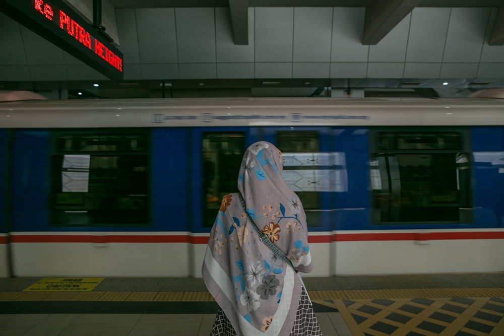 woman standing in front of train