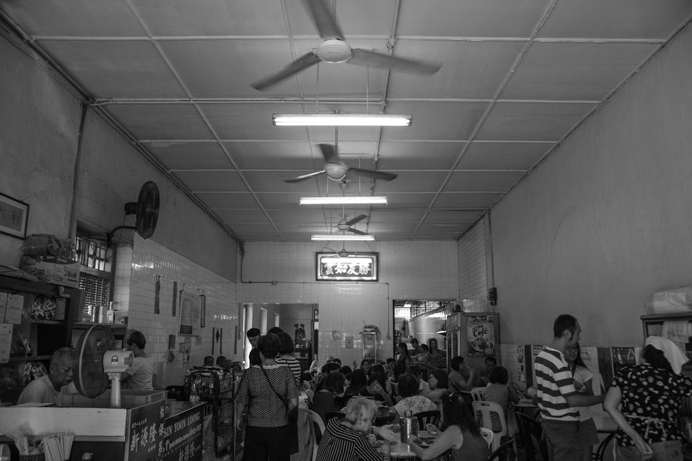 grayscale photo of people inside room