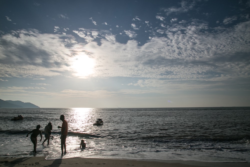 family playing at the beach