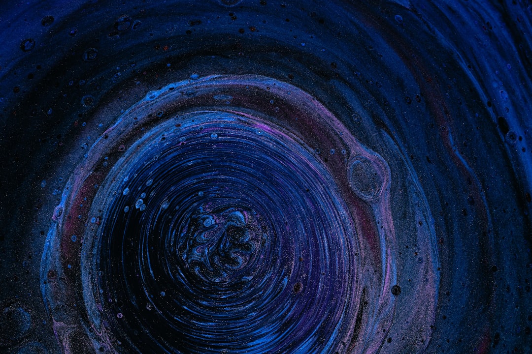 A space environment with black, blue, purple, and green colors
