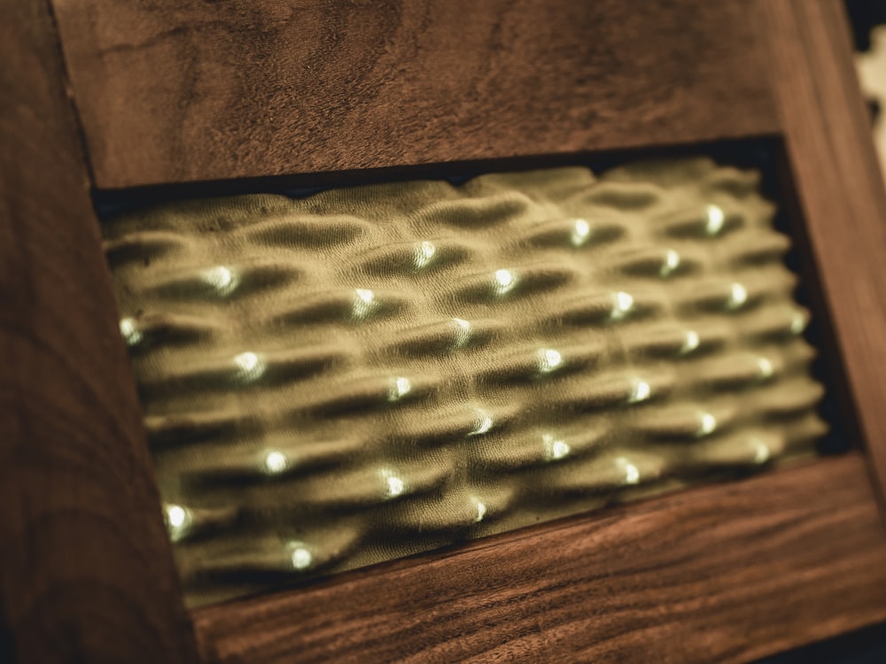 a close up of a wooden object with lights in it